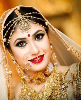 A Beautiful Bride resembles like a yellow flower with full of jewels on her neck and beautifully makeovered by the Bridal Makeup Artist.